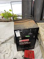 Front view of the Motomaster battery charger showing the rotary switch, ammeter, and brand label.