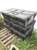 Three floats stacked on pallet outdoors