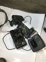 Four Humminbird fish finder head units grouped together showing front screens and control buttons.