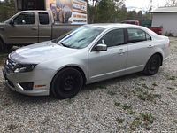 Front driver’s side three-quarter view showing silver exterior and steel wheels