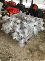 Pallet stacked with plastic-wrapped bundles of 5" wide engineered hardwood planks