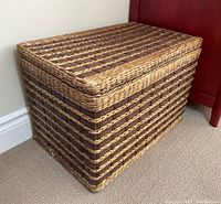Front and side view of the rectangular wicker basket showing the woven pattern and hinged lid.