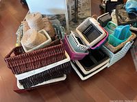 Photo showing stacked baskets of various materials including wicker, fabric, and plastic