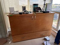 Front view of wood cabinet bed closed