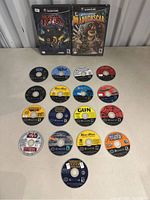 Two Nintendo GameCube game cases and 17 game discs arranged below.