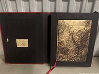 Photo of the open black slipcase with the limited edition Warhammer codex book inside, showing a collector's label inside the slipcase.