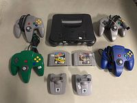 Console with four controllers, two game cartridges, and two transfer packs all arranged together for overview.