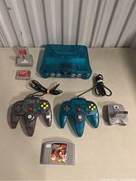 Overview of console, controllers, cables and paks laid out on table