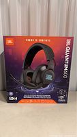 Front view of JBL Quantum 600 headset box showing model, branding, and key features like wireless 2.4 GHz connection and surround sound.