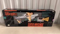 Image of original Super Nintendo Super Scope 6 box with visible graphics and branding