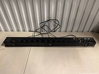 Sony black rectangular soundbar with speaker drivers, power cable, and control buttons visible.