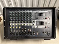 Front panel view of Yamaha EMX312SC showing channel inputs, knobs and faders.