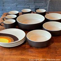 Full view of all 13 pieces including cups, bowls, serving dish, and plates arranged on table