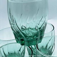 Close-up image showing green textured bottom and swirling pattern on the glass, highlighting the vintage design and color.