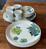 Overview of platter, bowls, and cups showing floral pattern and set layout