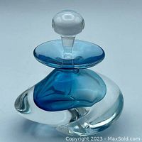 Photo of the perfume bottle showing the blue and clear glass design with stopper in place