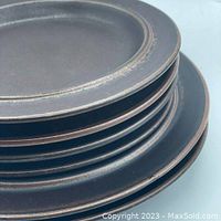 Stacked view showing the edge, pattern and condition of the plates.