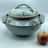 Full view of the covered studio pottery dish with apple for size reference.