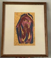Framed original linocut artwork titled "Woman" by Donna Ibing showing full view with wooden frame and white mat.