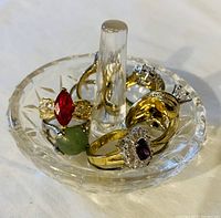Close-up view of crystal ring holder with 10 assorted ladies rings featuring colored and clear stones
