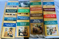 Top view of all 15 woodworking books laid out in 3 rows, titles clearly seen.