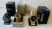 Three men's wristwatches in original boxes: Dickies, Sensor, George brand watches.