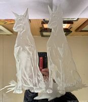 Close-up view of the etched Doberman Pinschers on the mirrored glass, showing detailed lines and beveled edges.