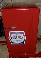 Front view of red mini fridge with Molson Canadian logo on door