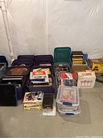 Overview of all tubs and boxes containing books and magazines, showing variety and number of containers.