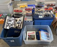 Top overview image showing tubs containing Corvette books and display cases with plastic model Corvette cars in various colors.