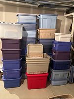 Full view showing stacked plastic storage tubs of multiple colors and sizes.