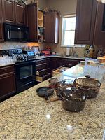Kitchen counter showing amber glass cookware and small frying pan grouped together