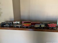 Wide shot of multiple train cars arranged in a row showing various colors and styles