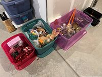 Four plastic tubs containing an assortment of holiday decorations including Valentine's and Easter items, partially visible contents showing various colors and shapes
