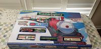 Original boxed Bachmann Yuletide Special train set with illustrated packaging featuring red and green Christmas train and passenger cars.