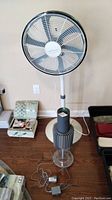 Full view of Bionaire floor fan and LifeAir air purifier on floor with other household items.