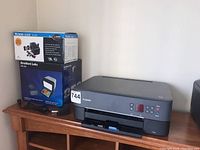 Canon Pixma TS5320 printer on wooden table with boxed slide converter and photo transfer scanner.