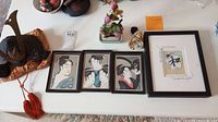 The entire lot including headpiece, three framed prints, modern framed art print, and glass flower decoration