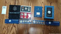 Overhead view of all coin sets laid out on wooden surface