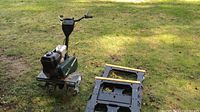 Photo of Craftsman gas powered roto tiller with 6.0 HP label and tilling blades, showing used condition with soil.