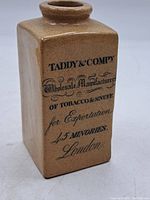 Front view showing black printed Taddy & Company Tobacco & Snuff text