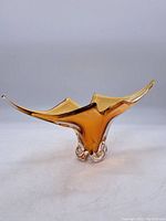 Full side view of the amber art glass vase showing the overall shape and color gradient.