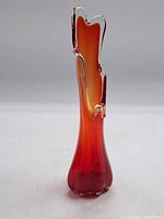 Full front view of the tall art glass vase showing clear glass accents and vibrant orange to red gradient color.