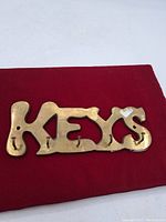 Front view of solid brass key holder with embossed letters 'KEYS'.