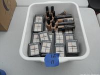 Overview of all Sonia Kashuk makeup items in white storage bin showing multiple eye shadow quads, foundation sticks, and nail polishes.