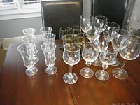 Overview image showing the grouping of three types of glassware: etched fluted, smoked fluted, and clear wine glasses on a table surface