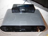 Side angle showing Sony clock radio with iPhone/iPad dock station on top, black and silver color scheme