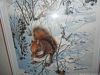 Close-up photo of the print showing the red squirrel in snow with naturalistic detail