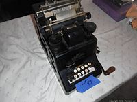 Front angle view showing Dalton adding machine with keys, crank, and branding.