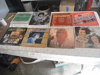 Nine vinyl record albums laid out on a table showing full covers including Country Gold, Dynamites, Sound Express, Burton Cummings, and others.